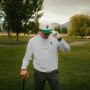 Golfer wearing the Veros Founders Hat and quarter zip on course