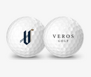 Two white Vice Drive golf balls customized with Veros Golf logos